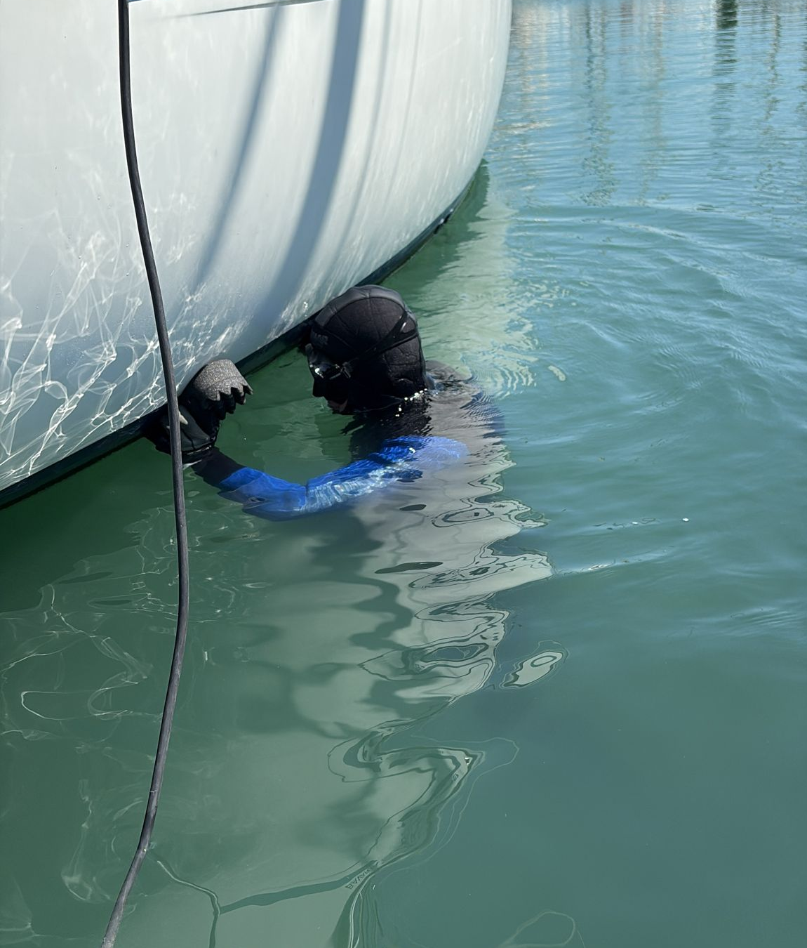 Up & Clean's certified diver hand-cleaning a hull at the waterline